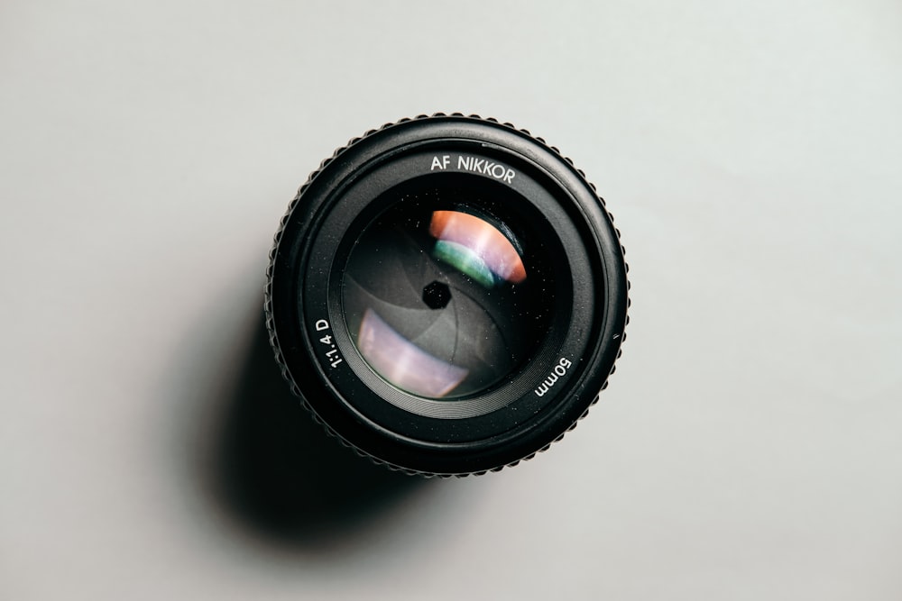 black camera lens on white table