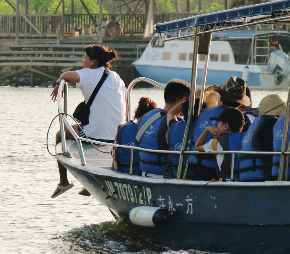 people riding on blue boat during daytime