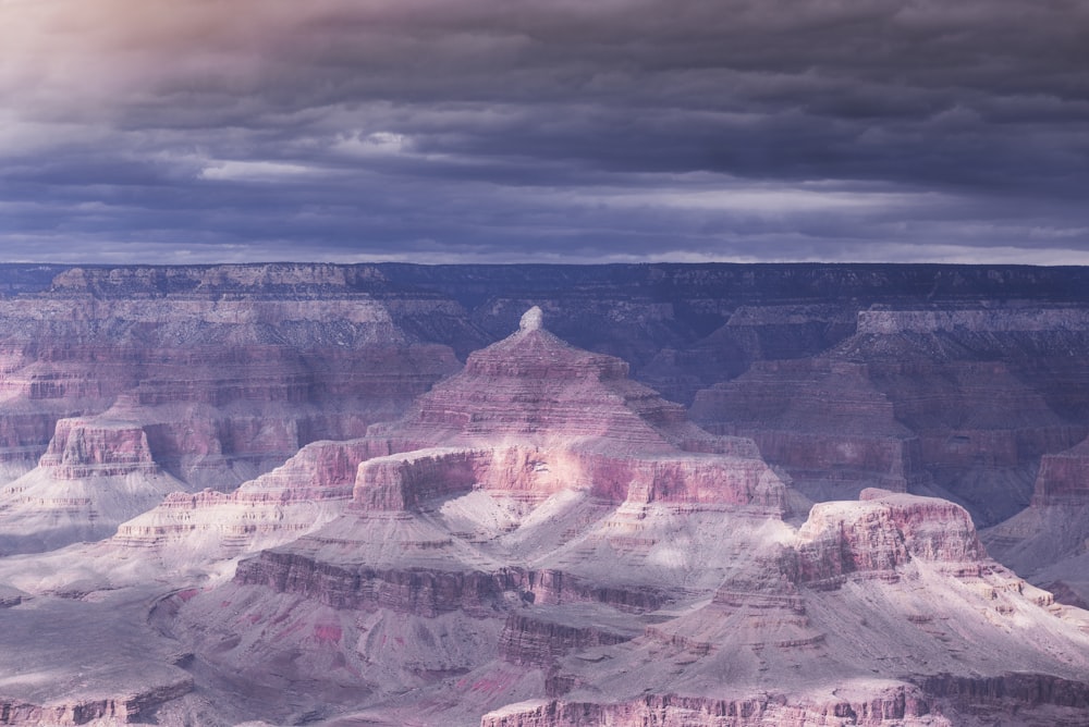 brown rock formation under gray clouds during daytime