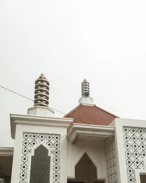The exterior of Hotel El Mensario blending modern minimalism with medieval architectural details.
