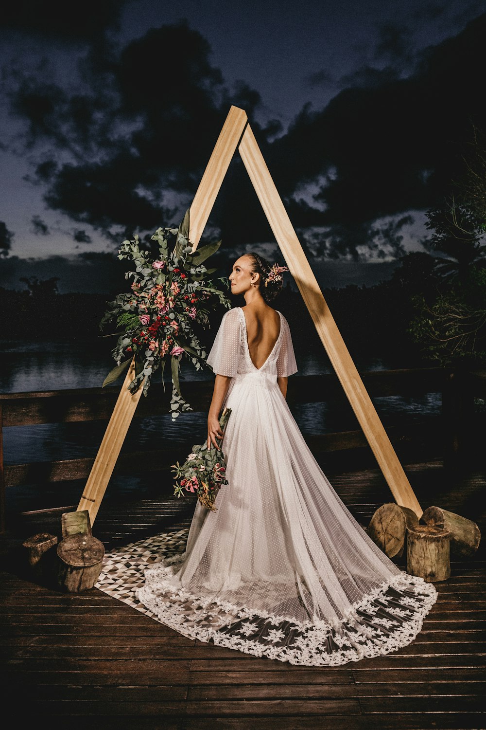 woman in white wedding dress standing on brown wooden ladder