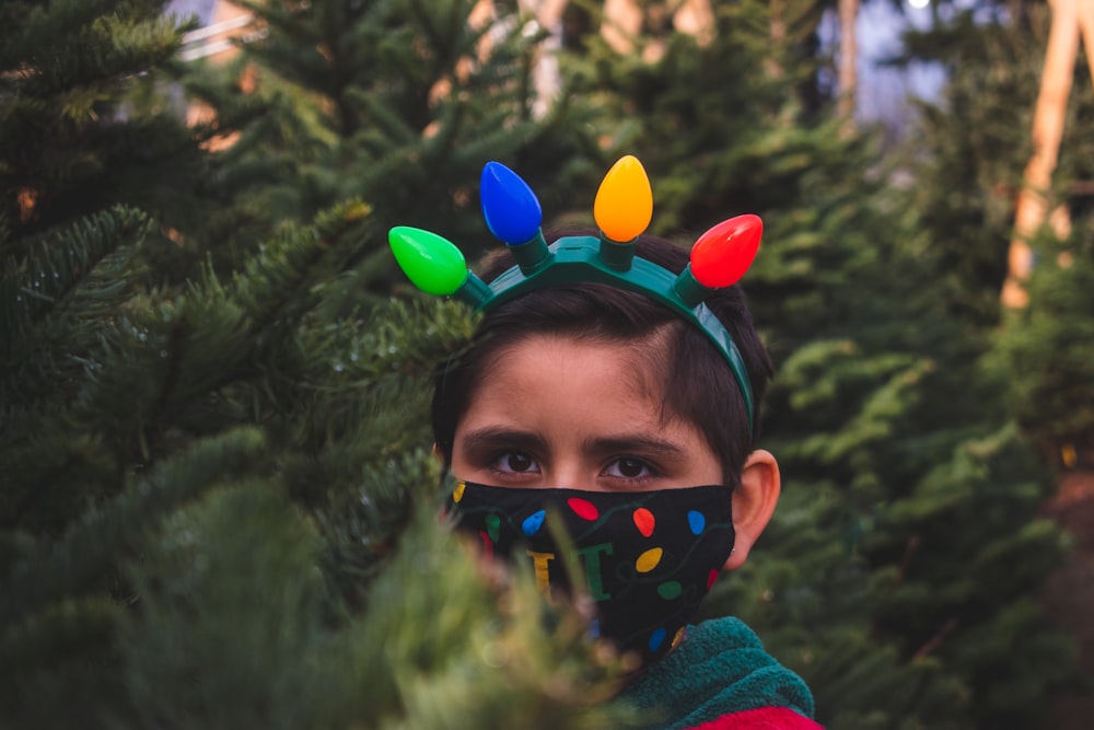 woman in green hoodie with balloons on her head