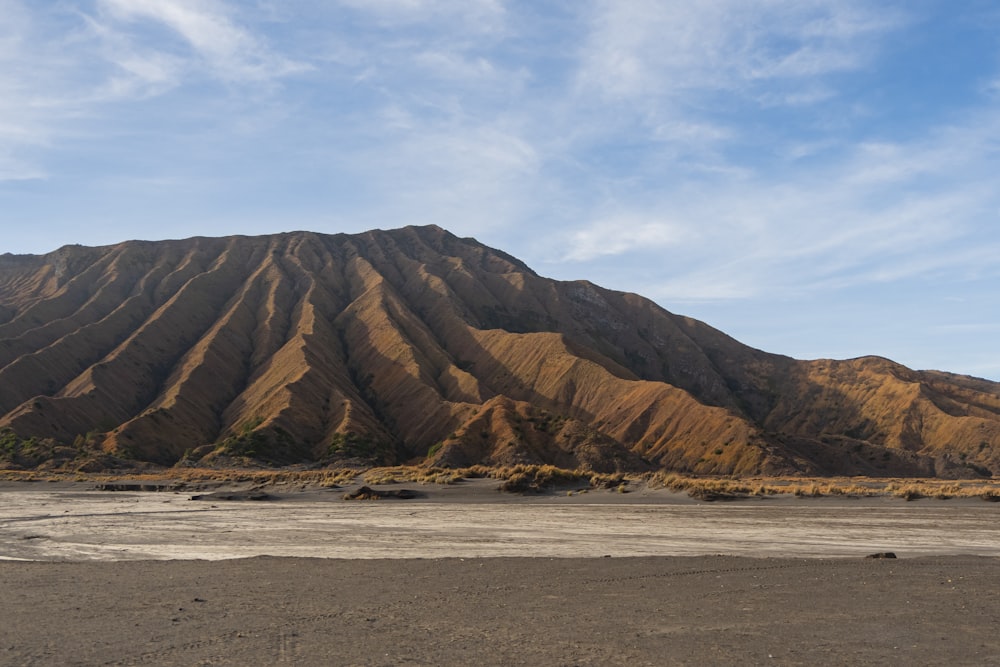 brown rock formation under white clouds during daytime