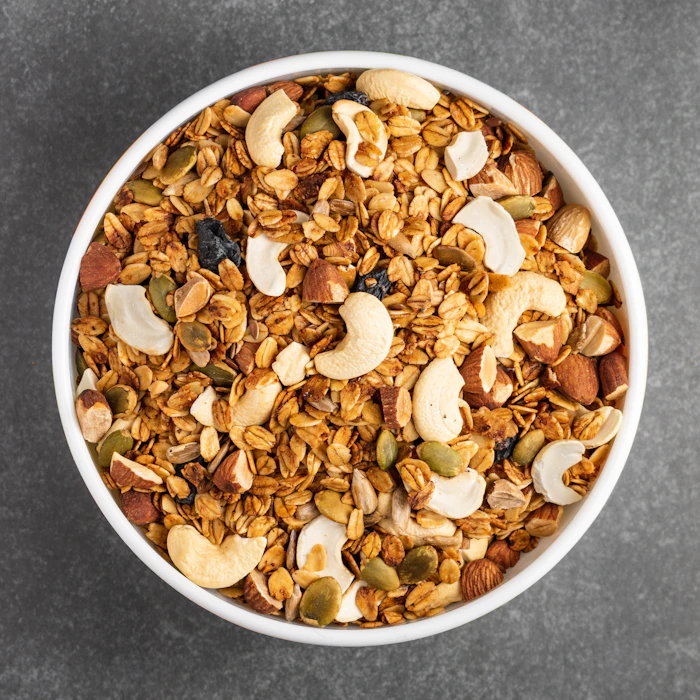 White ceramic bowl with brown dry fruits and nuts