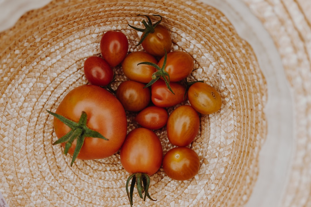 orange and red tomato on brown woven basket