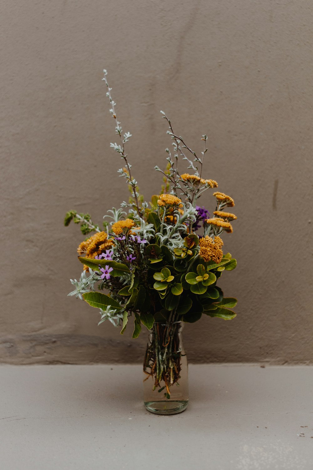 Dried Wildflowers Many Tiny Blue And Yellow Flowers In A Transparent Glassy  Vase Bouquet On A Gray Background Stock Photo - Download Image Now - iStock