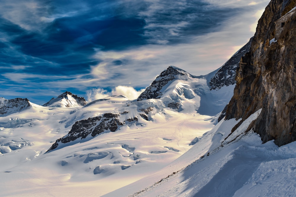 snow covered mountain under blue sky during daytime