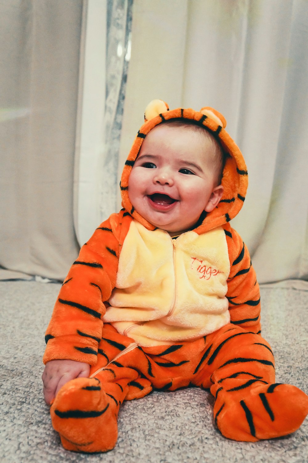 baby in orange and white stripe onesie