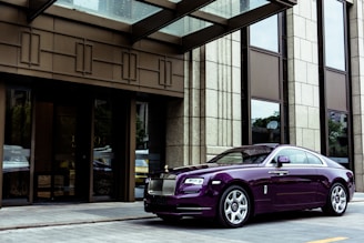 Finished modern building exterior with reflective chrome and deep purple accents.