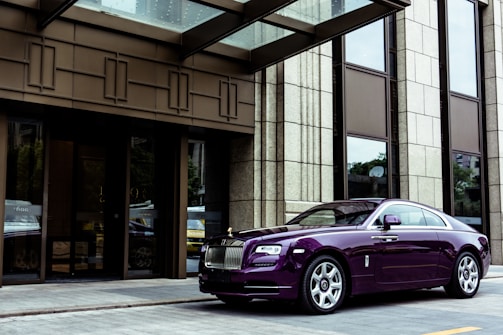 Finished modern building exterior with reflective chrome and deep purple accents.