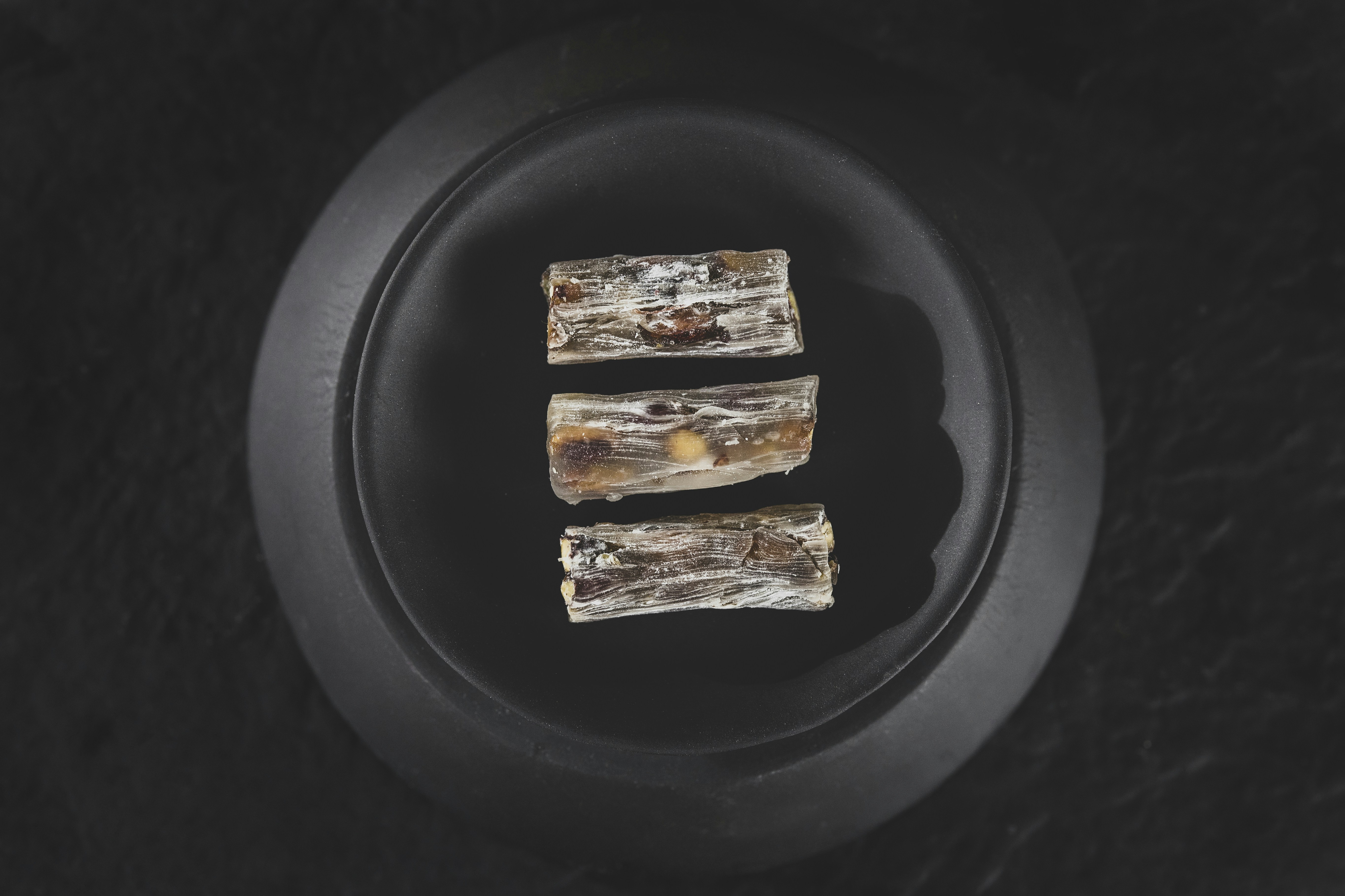 2 brown and white food on black plate, Turkish delight</p><p>