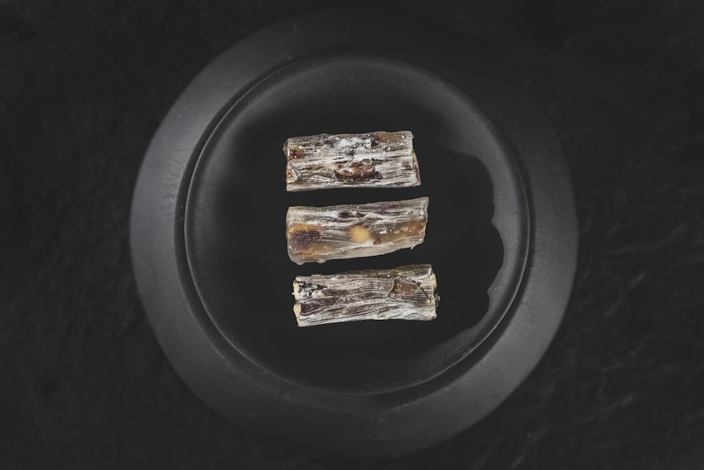 2 brown and white food on black plate