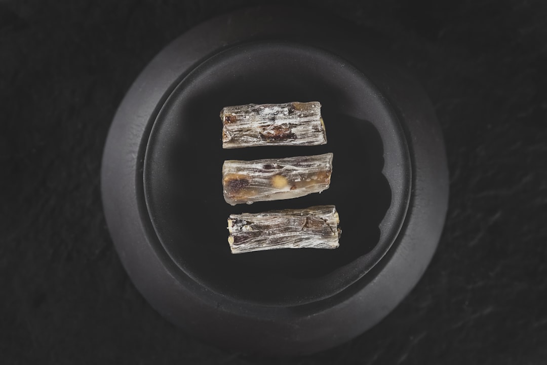2 brown and white food on black plate, Turkish delight<p></figure>