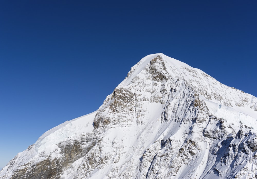 snow covered mountain under blue sky during daytime