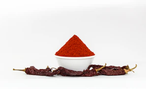 Close-up of vibrant groundnut chutney powder in a rustic bowl with a wooden spoon