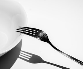 silver fork on white ceramic plate
