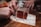 Close-up of hands collaborating over printed game materials on a wooden table.
