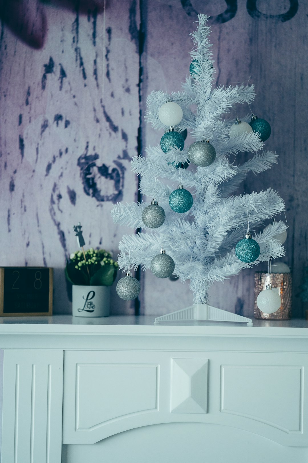 white and blue christmas tree on white wooden cabinet