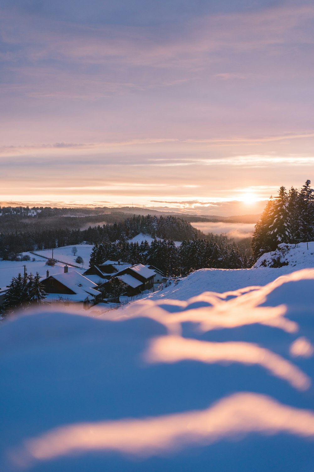 snow covered field during sunset