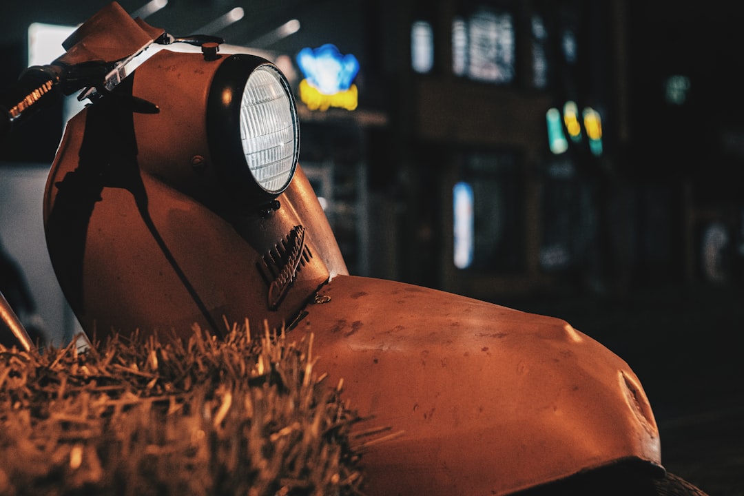 orange and black motorcycle with light