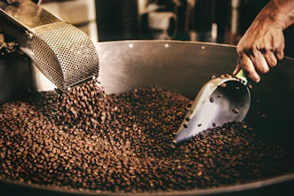 black and white ceramic fish figurine on black and brown coffee beans