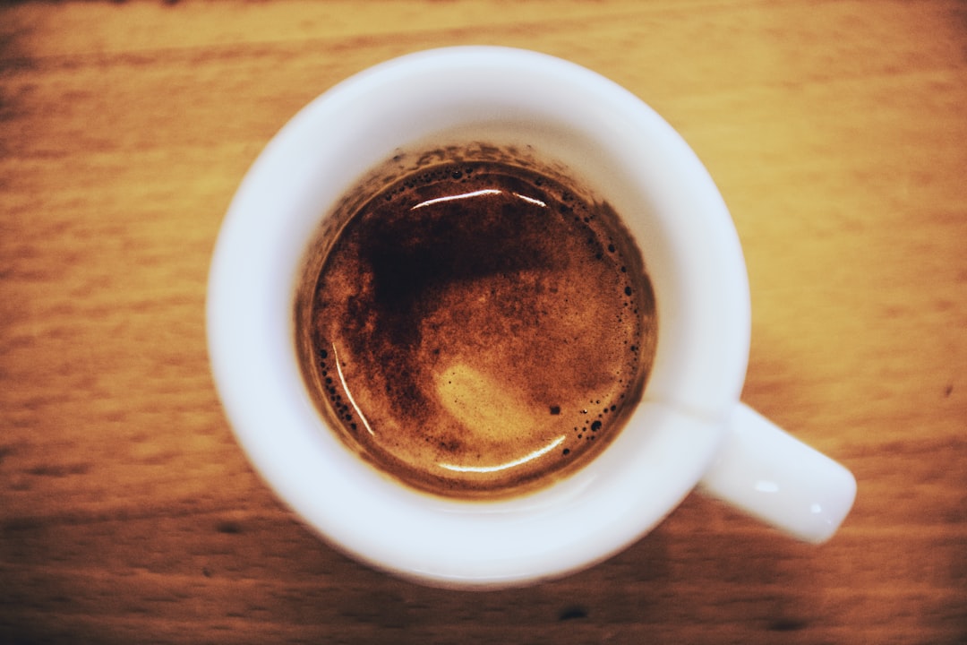 white ceramic mug with brown liquid