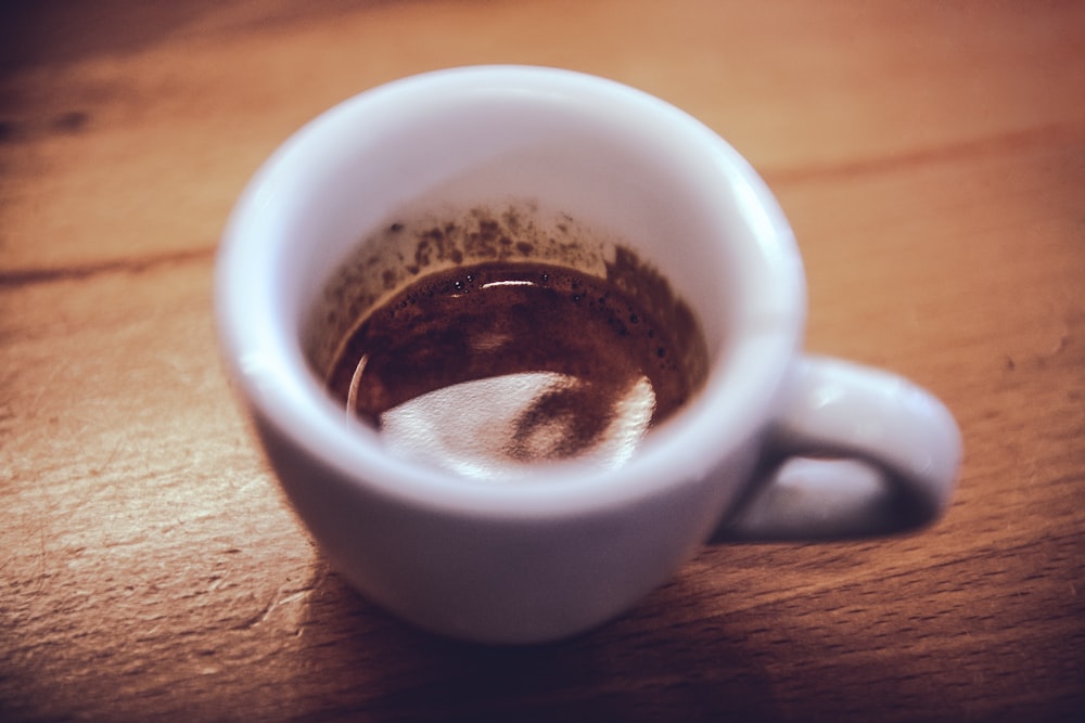 white ceramic mug with brown liquid