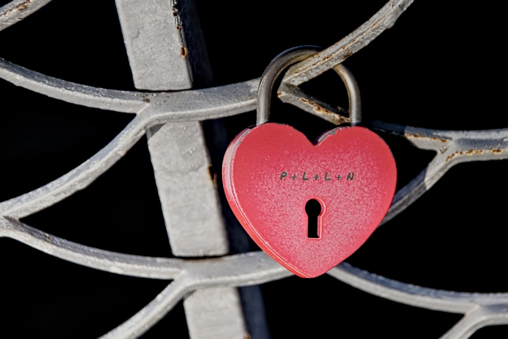 red padlock on grey metal fence