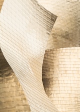 Close-up of brushed gold textures blending into sleek modern architectural lines.