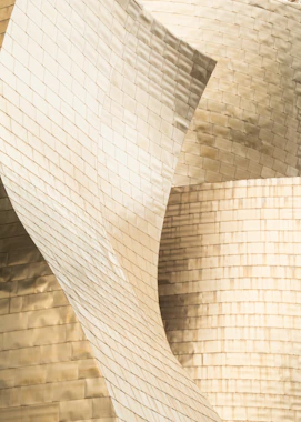 Close-up of a modern architectural detail with textured dark surfaces and subtle gold accents.