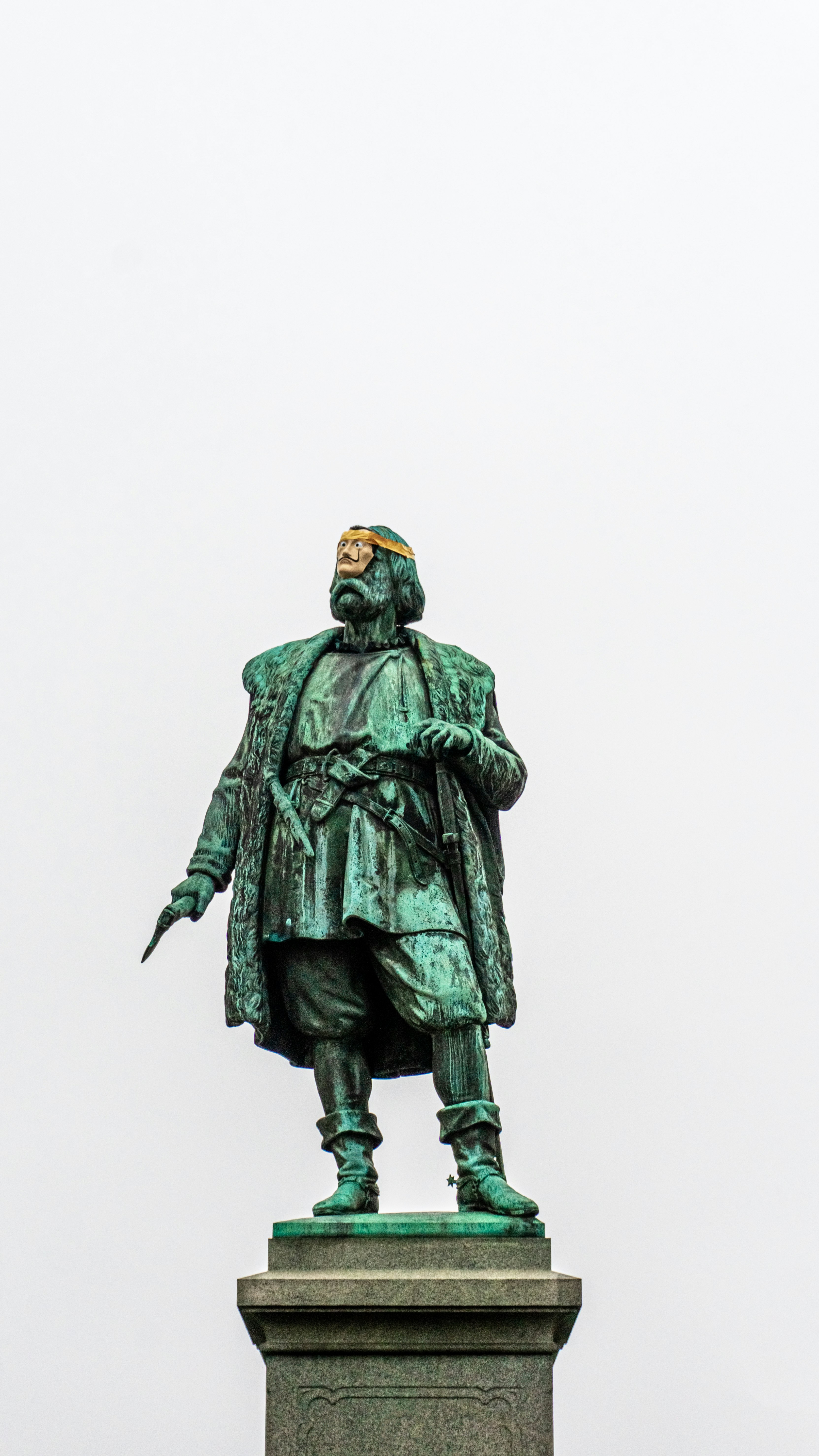 man in green coat statue