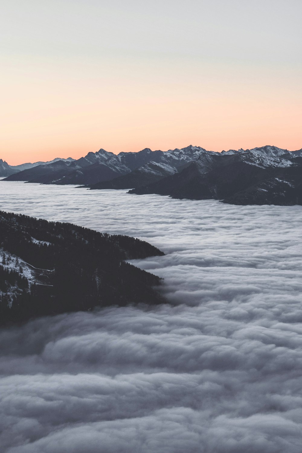 snow covered mountain during sunset