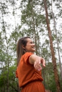 A smiling woman embracing nature.