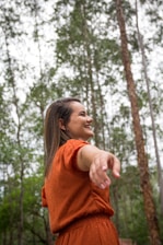 A smiling woman embracing nature.