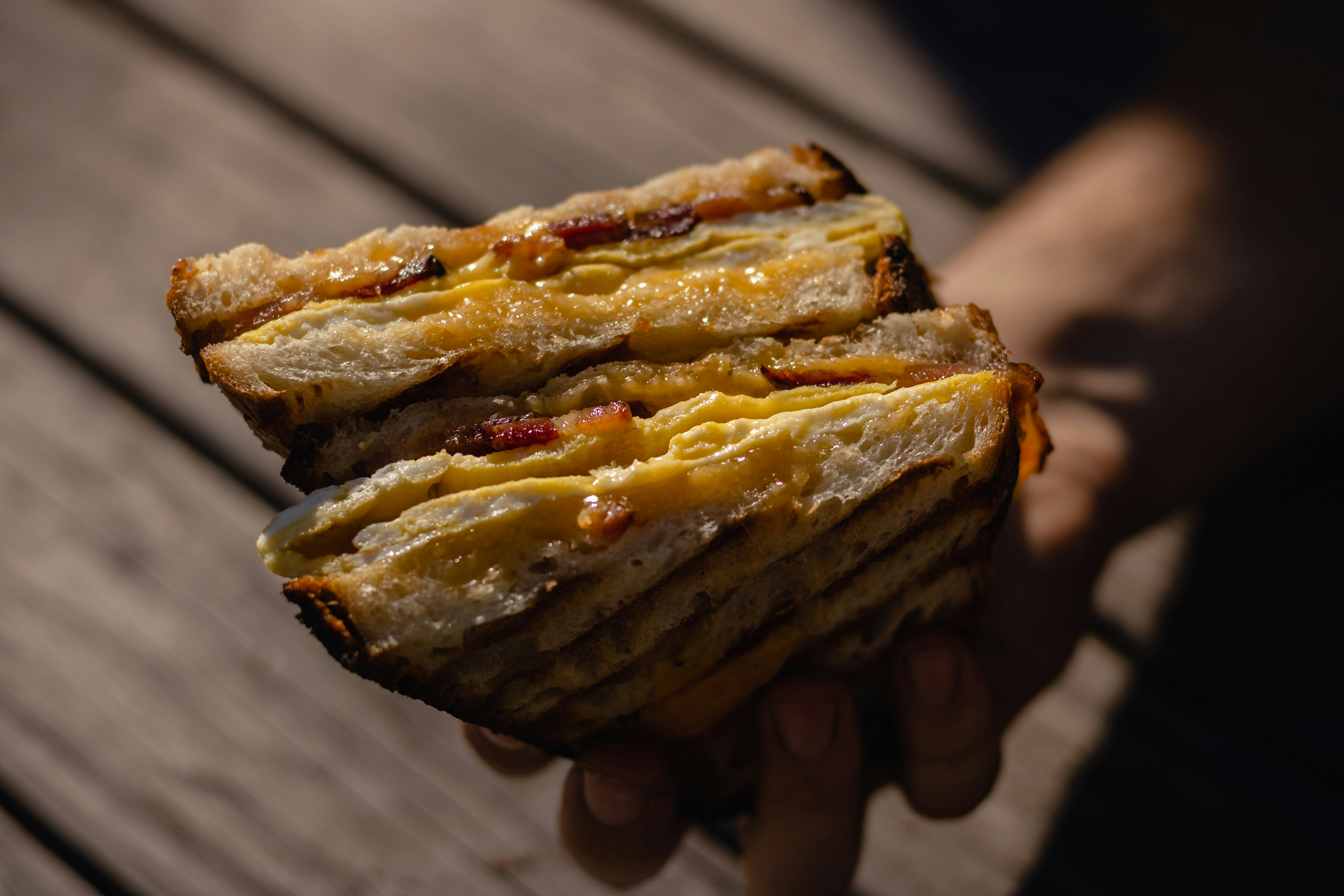 person holding a brown pastry