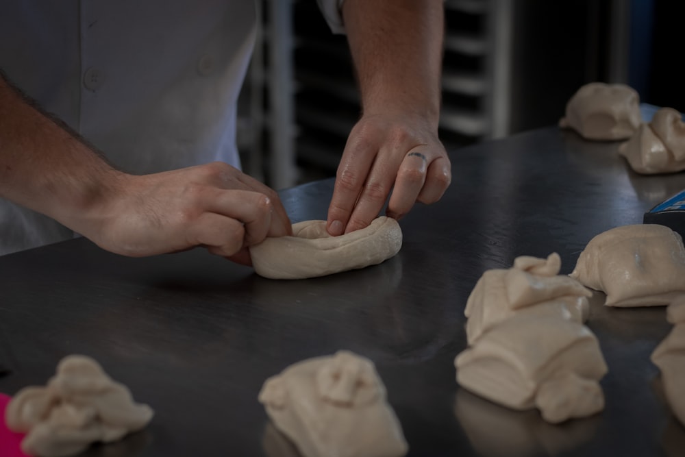 person holding dough on table