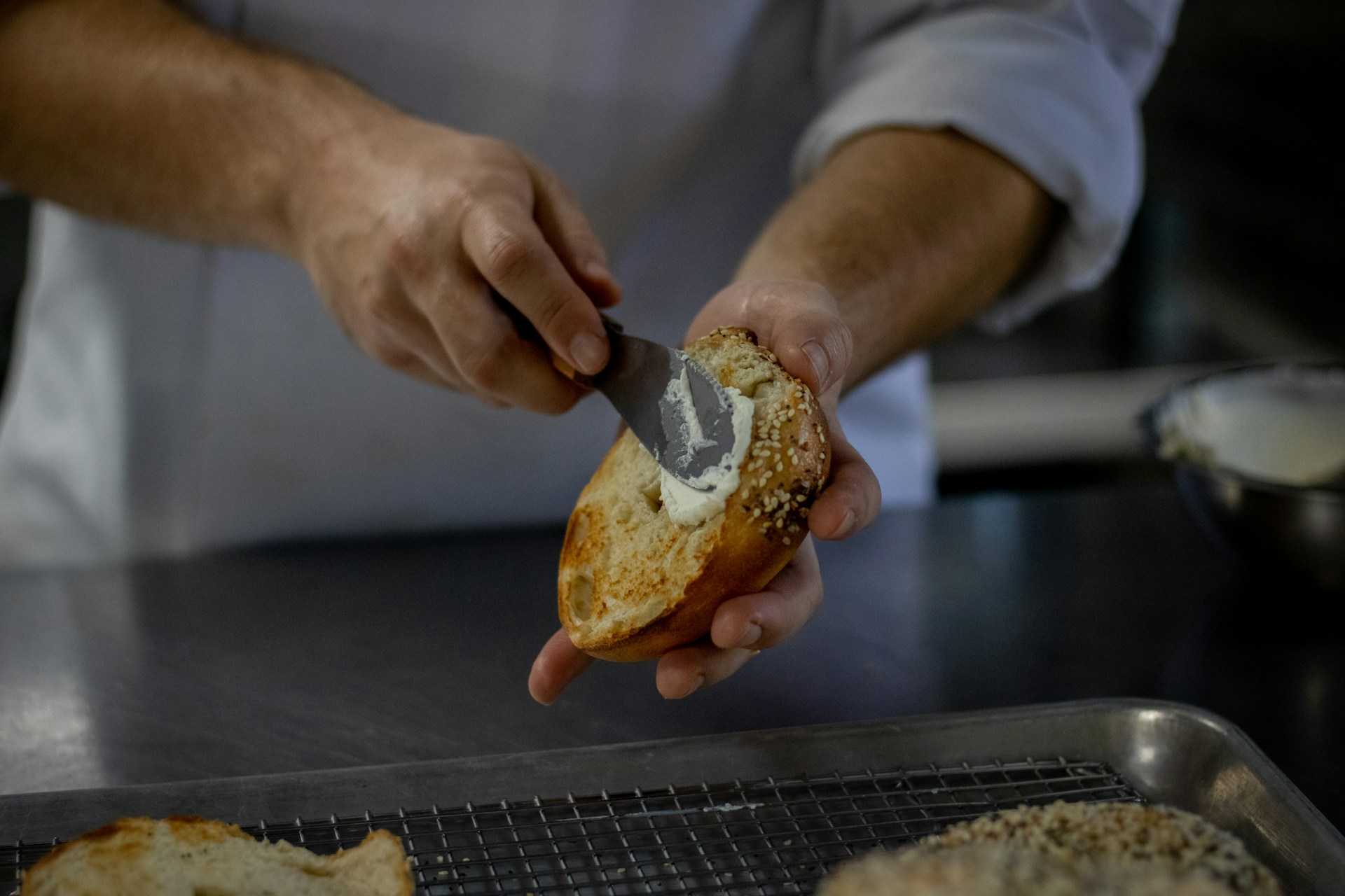 person holding bread with chocolate filling