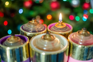 Colorful candles displayed at a festive event with soft glowing lights.