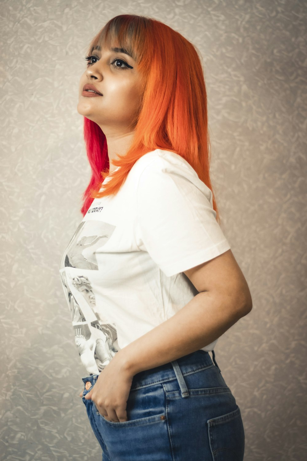 woman in white crew neck t-shirt and blue denim jeans