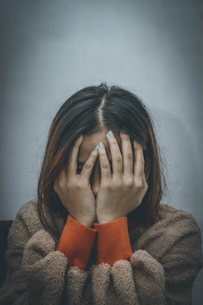 Woman covering her face with hands representing anxiety and depression therapy Oregon