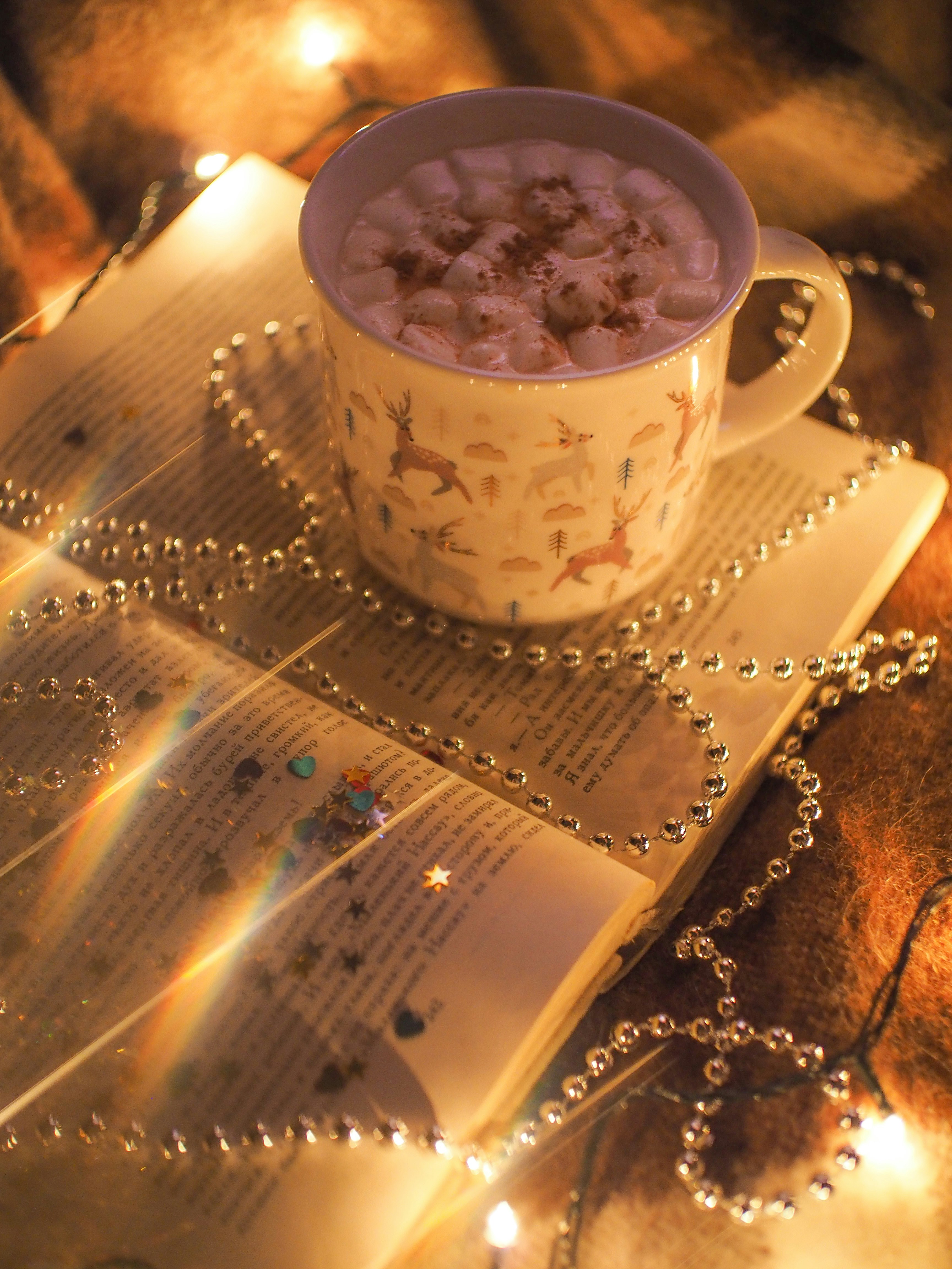white ceramic mug on white and brown table cloth