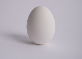 2 white eggs on white surface