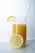 clear drinking glass with yellow liquid and sliced lemon