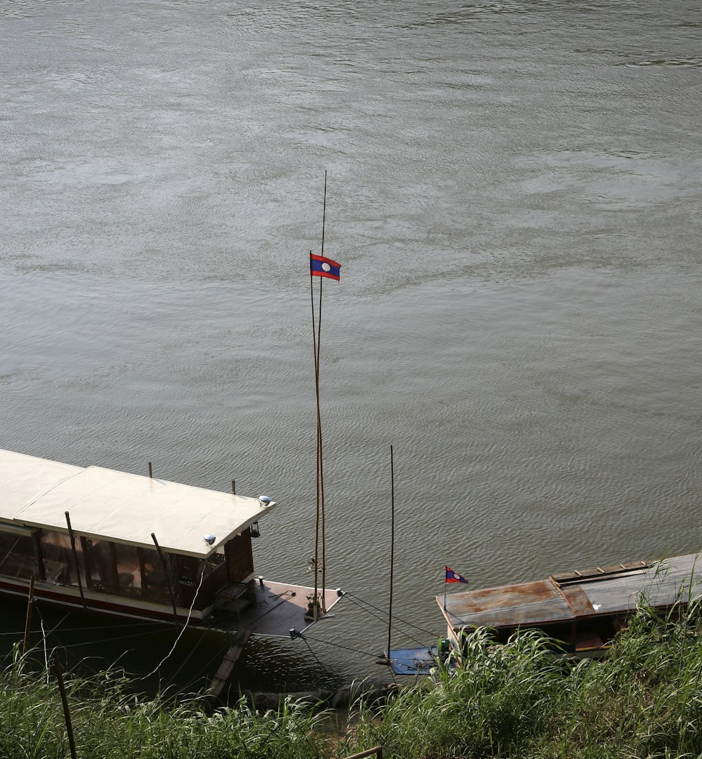 white and brown boat on body of water during daytime