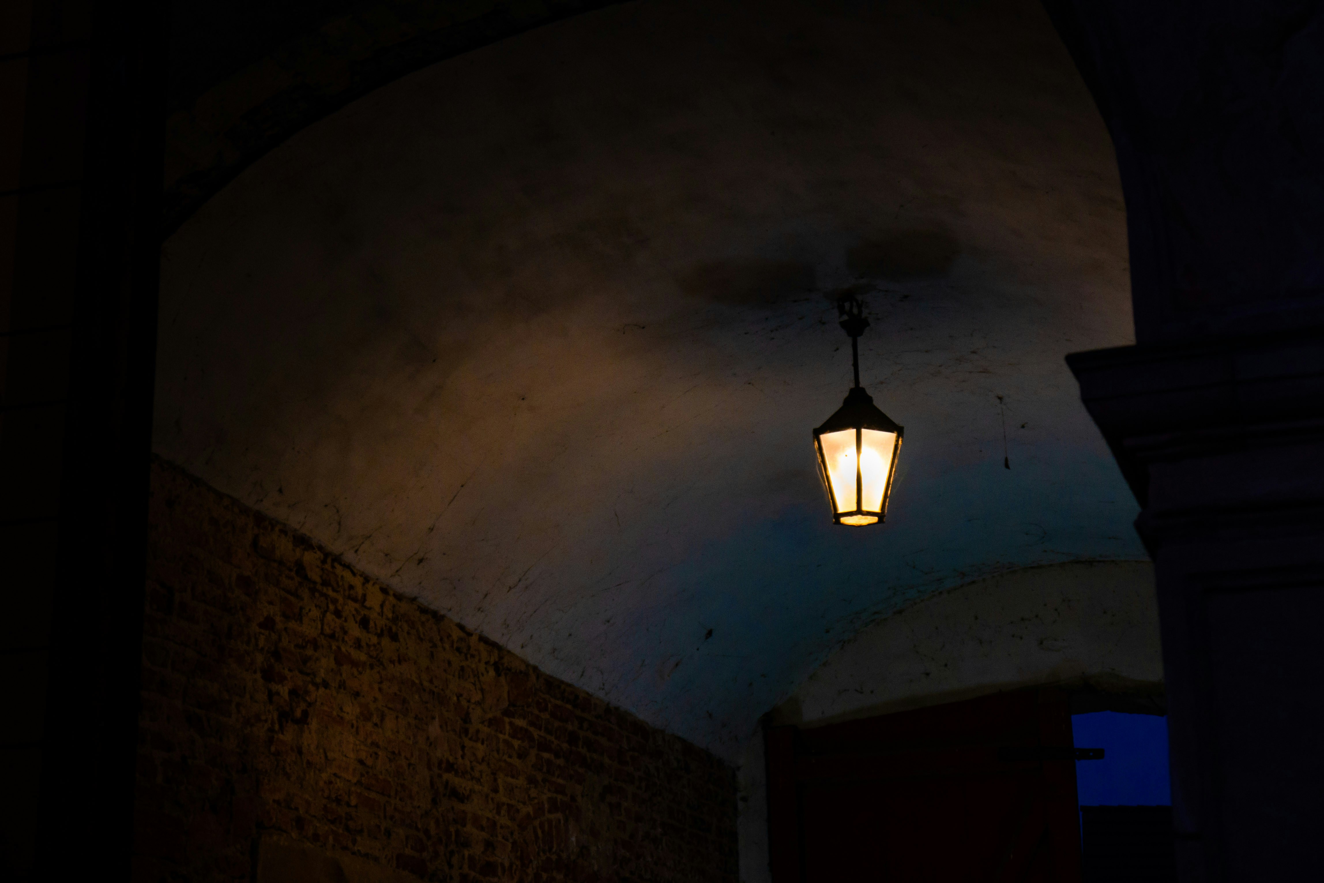 black pendant lamp turned on in a room