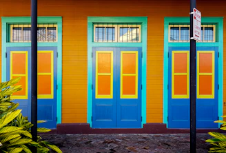 brown wooden door on purple painted wall