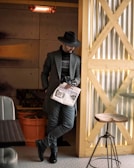 A stylish man lounging in a modern cafe, showcasing easewalk loafers.