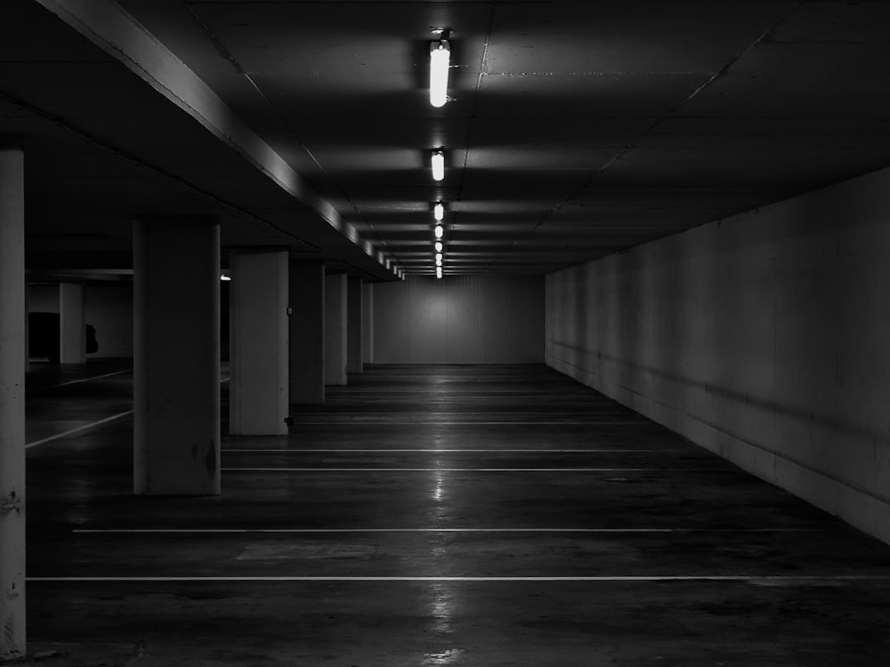 grayscale photo of hallway with lights