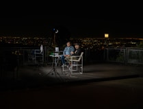 2 person sitting on chair during night time