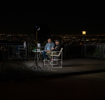 2 person sitting on chair during night time